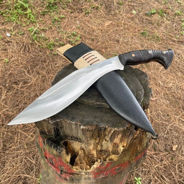 Shape gurkha khukuri with shining blade with black leather sheath placed on wooden log in forest for camping